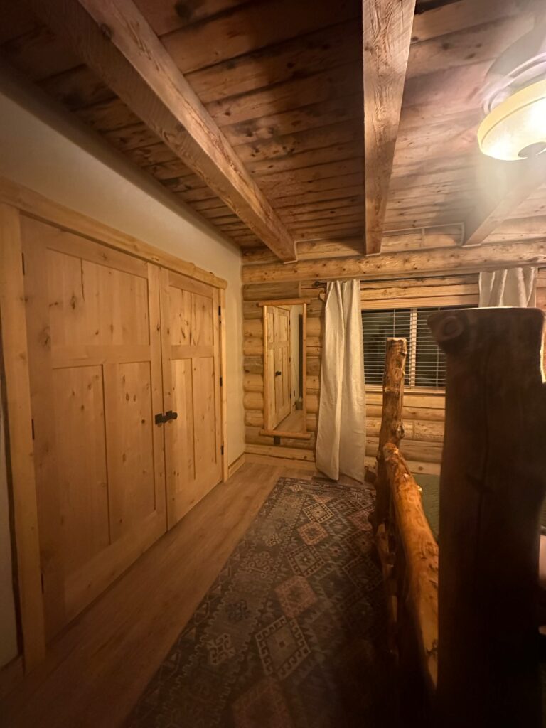 Comfortable bedroom inside a cozy cabin in Dutch John, Utah.