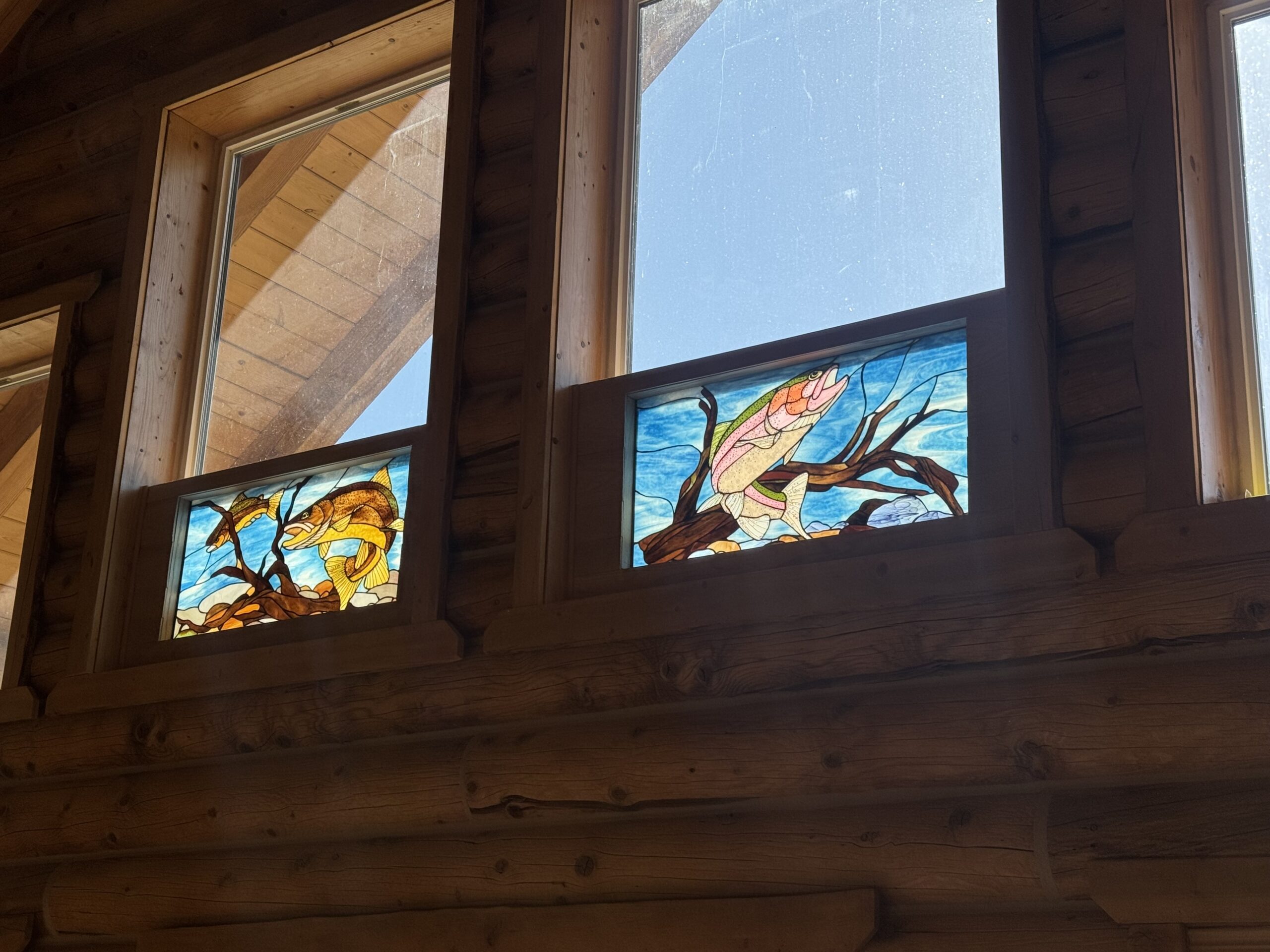 Final installed stained glass window viewed from inside the cabin.