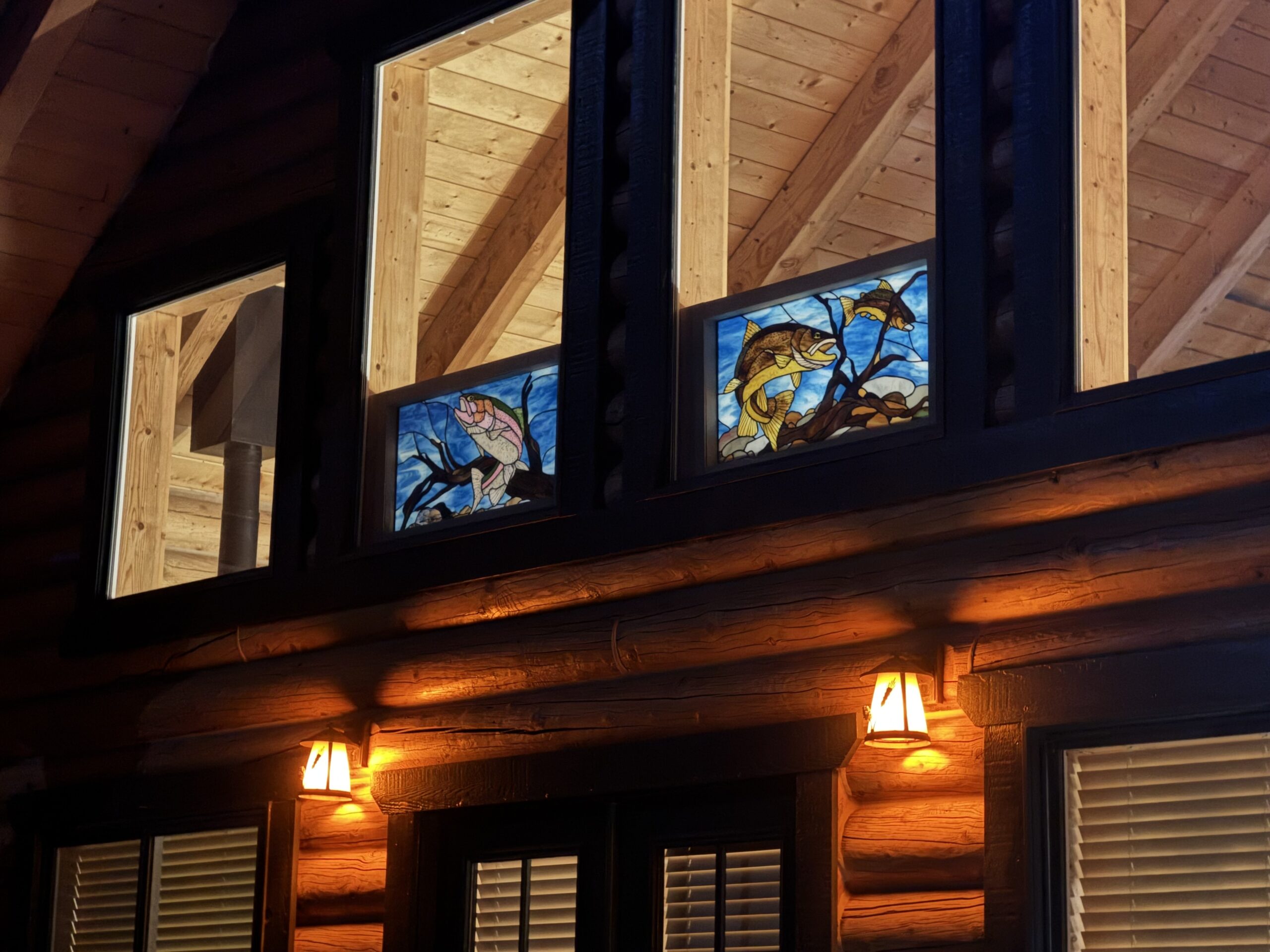 Angled nighttime view of the installed stained glass windows.