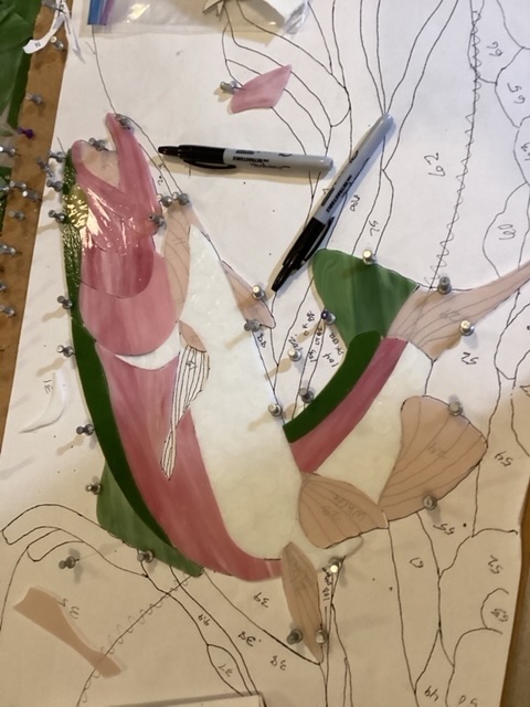 Rainbow trout panel in mid-assembly, showing partially joined pieces.