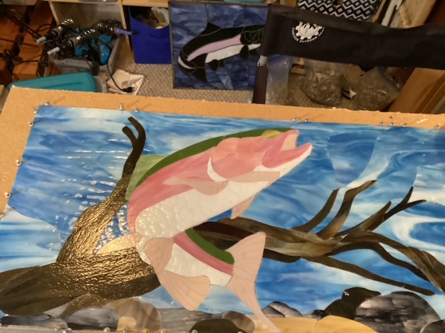 Rainbow trout panel laid out on template with glass pieces arranged.